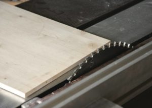 sharp saw blade and a wood on table saw top